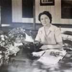 Majorie Kinnan. Rawlings author of The Yearling sitting at her table writing
