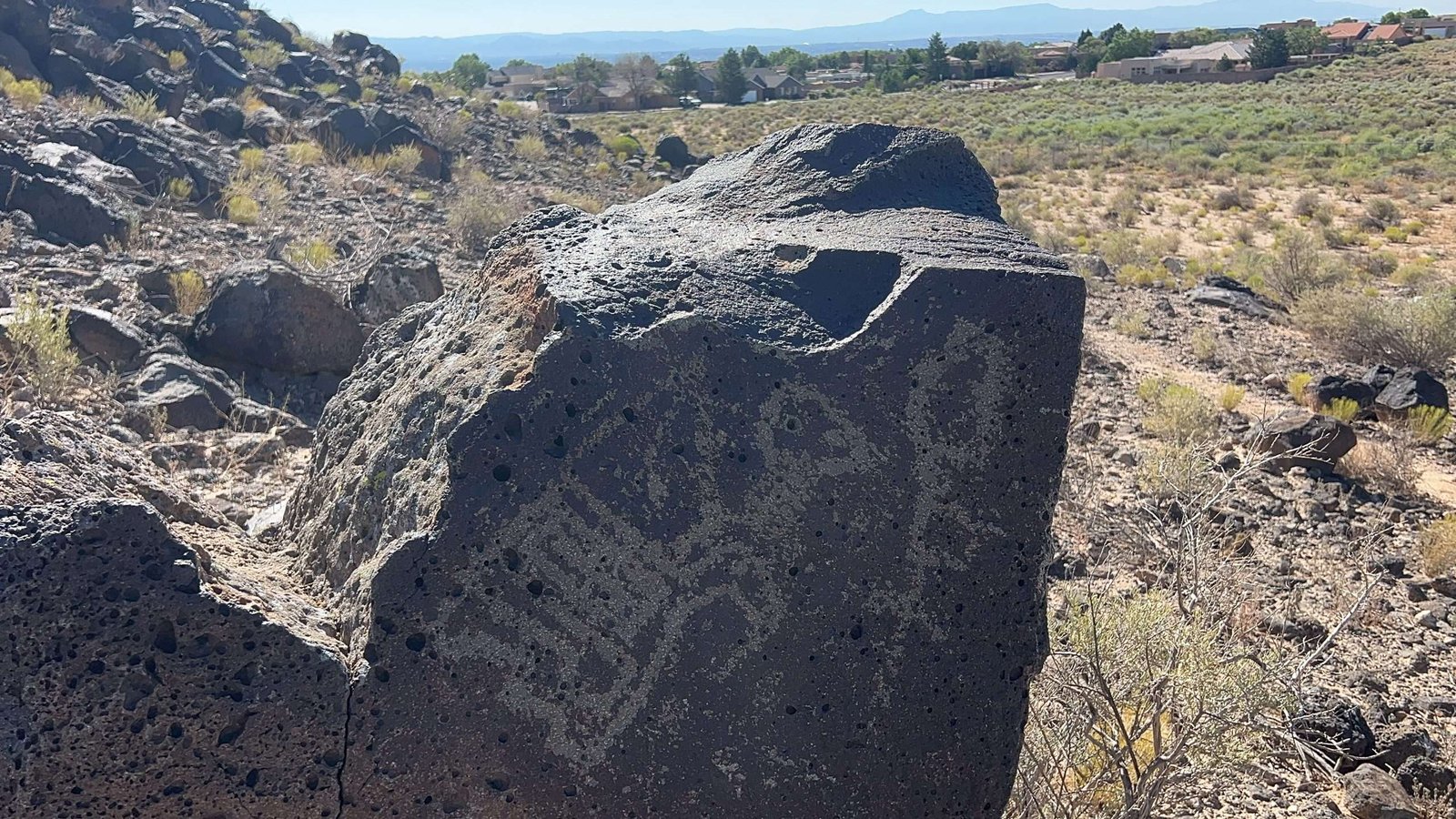 Petroglyph National Monument near Albuquerque, New Mexico. Rock with ancient petroglyphs against the backdrop of the Rio Grande Valley