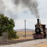 steam locomoties facing off at Promitory POint in Utah where the golden spike was laid connected America